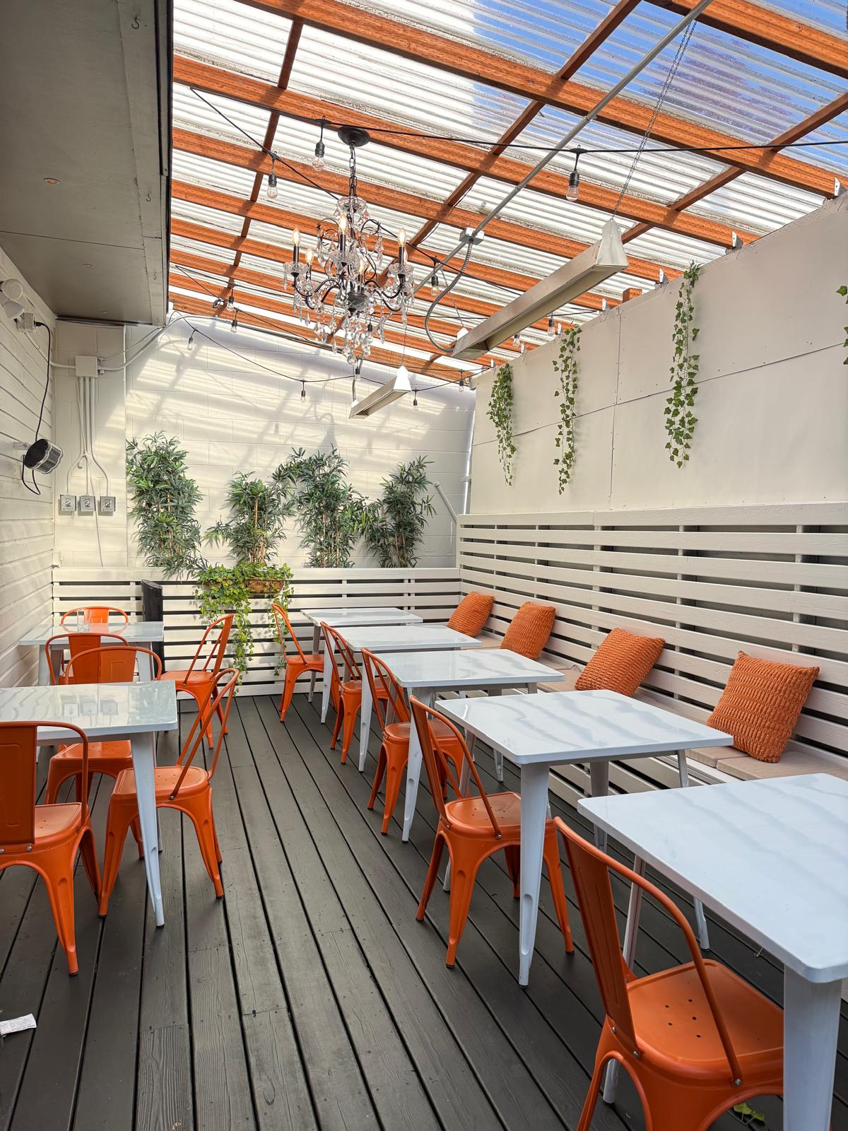 Patio seating with orange chairs and bamboo plants
